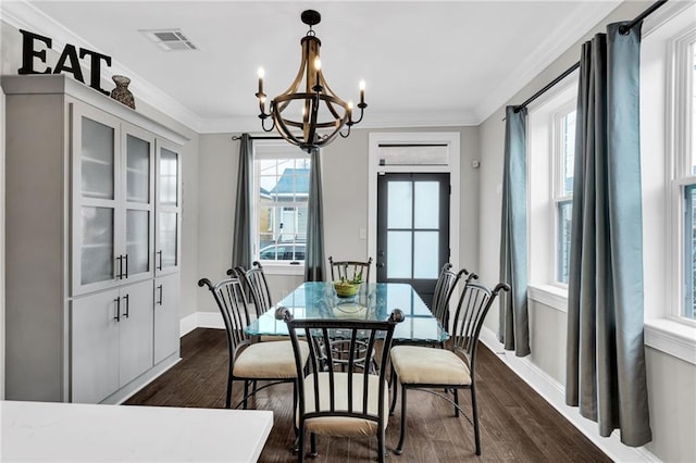 1508 N Roman St, New Orleans, LA 70116 - dining room featuring baseboards, ornamental molding, a chandelier, visible vents, and dark wood finished floors