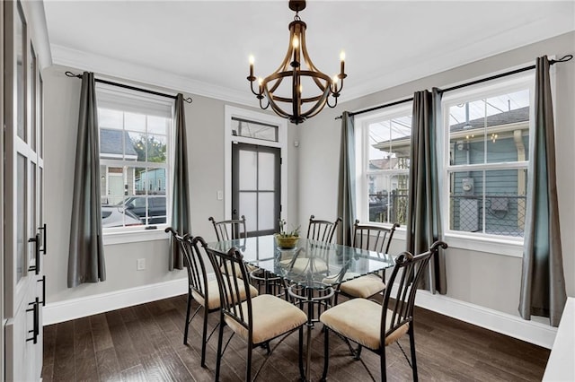 1508 N Roman St, New Orleans, LA 70116 - dining area featuring dark wood-type flooring, a notable chandelier, baseboards, and crown molding