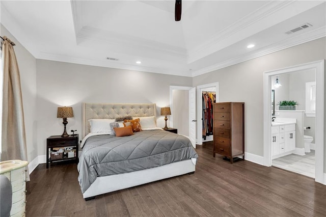 1508 N Roman St, New Orleans, LA 70116 - bedroom with a walk in closet, visible vents, crown molding, and dark wood finished floors