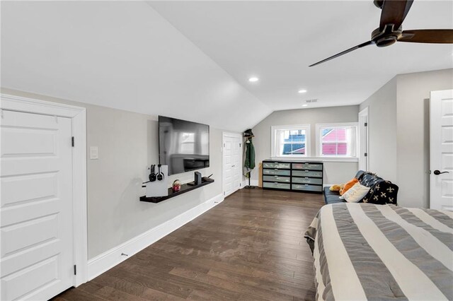 bedroom featuring ceiling fan, dark hardwood / wood-style floors, and vaulted ceiling