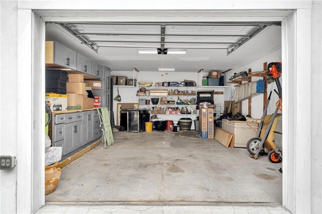 garage with a garage door opener and a workshop area