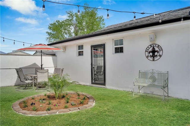 1508 N Roman St, New Orleans, LA 70116 - rear view of property with a yard and stucco siding
