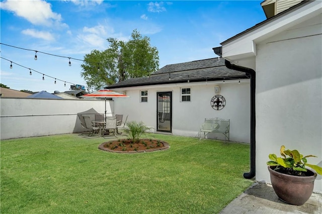 1508 N Roman St, New Orleans, LA 70116 - rear view of house with a yard, stucco siding, fence, and a patio area