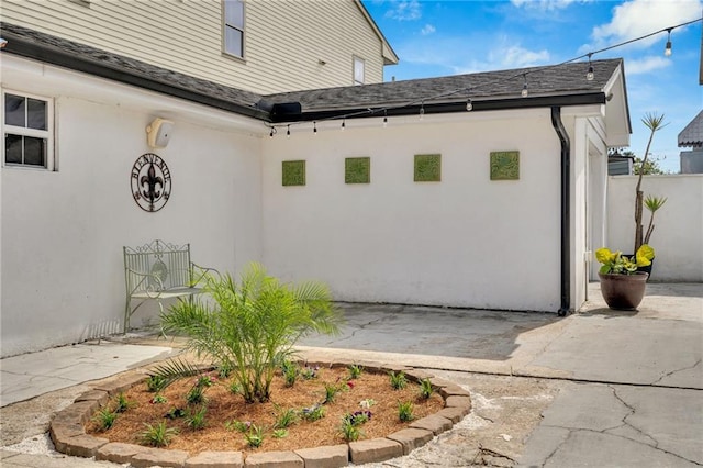 1508 N Roman St, New Orleans, LA 70116 - view of home's exterior featuring fence, a shingled roof, a patio, and stucco siding