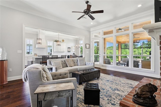 living room with ceiling fan with notable chandelier, dark hardwood / wood-style floors, and a healthy amount of sunlight