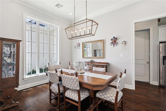 dining room featuring a notable chandelier, crown molding, and dark wood-type flooring