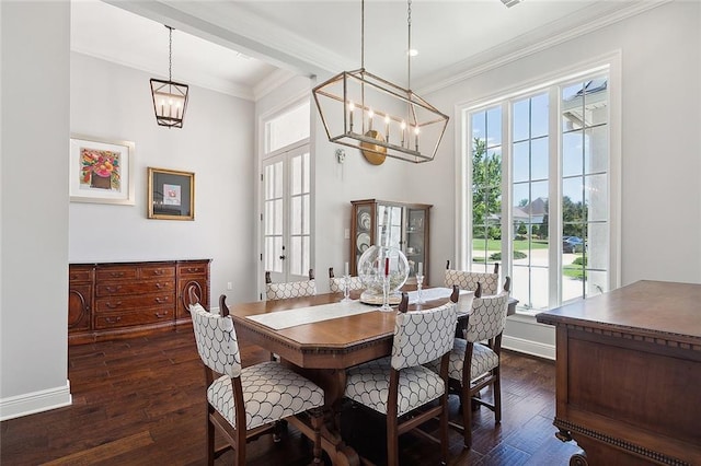 dining room with crown molding, dark hardwood / wood-style flooring, and a chandelier