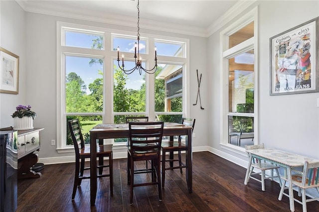 dining room featuring dark hardwood / wood-style flooring, an inviting chandelier, and ornamental molding