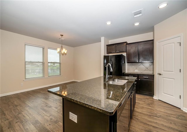 kitchen featuring sink, an inviting chandelier, pendant lighting, black fridge with ice dispenser, and dark brown cabinets