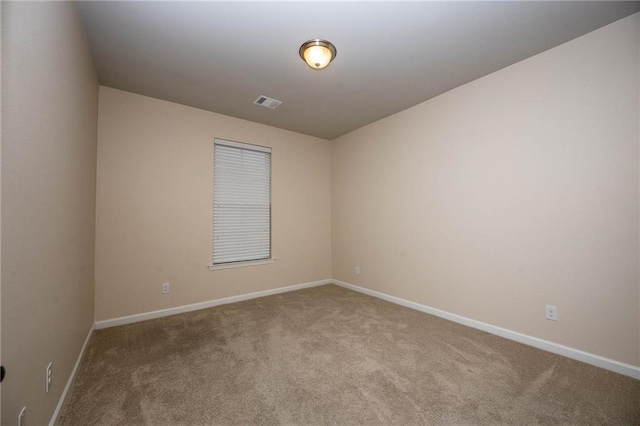 empty room featuring light carpet