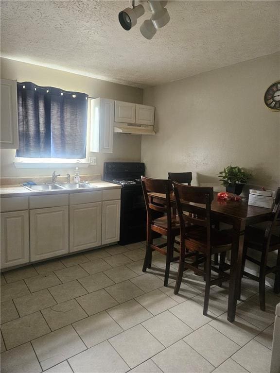 kitchen featuring white cabinetry, black / electric stove, sink, and a textured ceiling