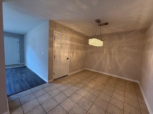 unfurnished dining area with light tile patterned floors