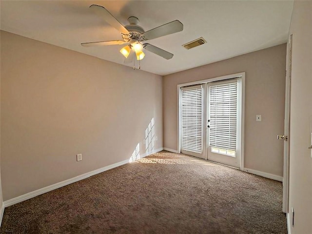 carpeted spare room featuring french doors and ceiling fan