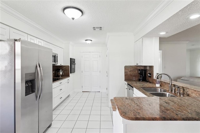 kitchen featuring backsplash, kitchen peninsula, sink, appliances with stainless steel finishes, and white cabinetry