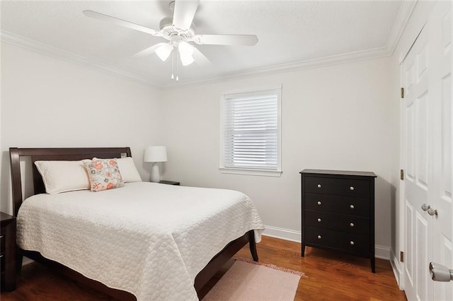 bedroom featuring hardwood / wood-style flooring, ceiling fan, and crown molding