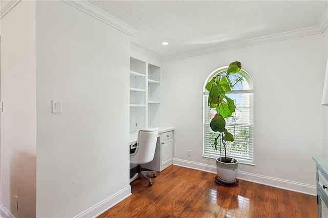 office space featuring dark hardwood / wood-style floors, built in features, ornamental molding, and a textured ceiling