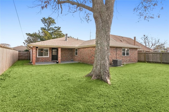 rear view of property with central AC unit, a patio area, and a lawn