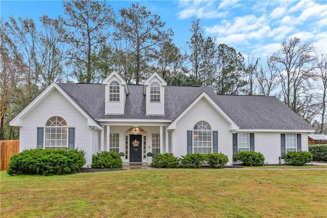 cape cod-style house with a front yard