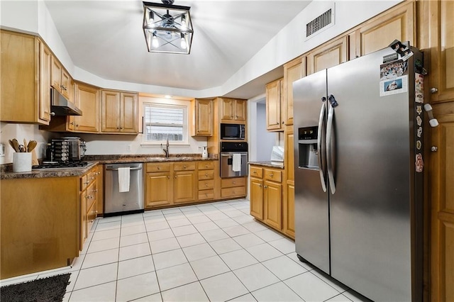 kitchen with appliances with stainless steel finishes, sink, light tile patterned floors, decorative light fixtures, and lofted ceiling