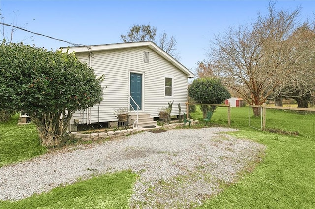 rear view of house featuring a yard