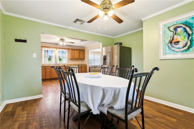 dining space with ceiling fan, dark wood-type flooring, and ornamental molding