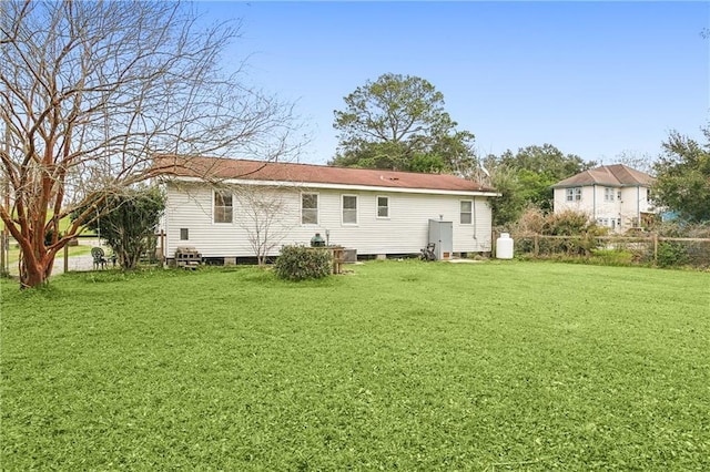 back of property featuring a lawn
