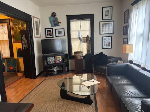 living room with plenty of natural light and dark hardwood / wood-style floors