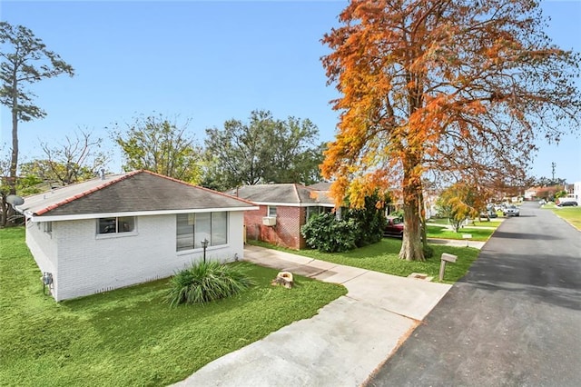 view of side of home with a yard