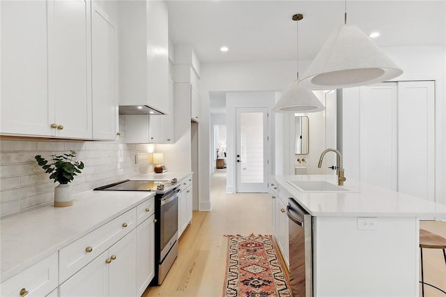 kitchen featuring white cabinets, sink, hanging light fixtures, and appliances with stainless steel finishes