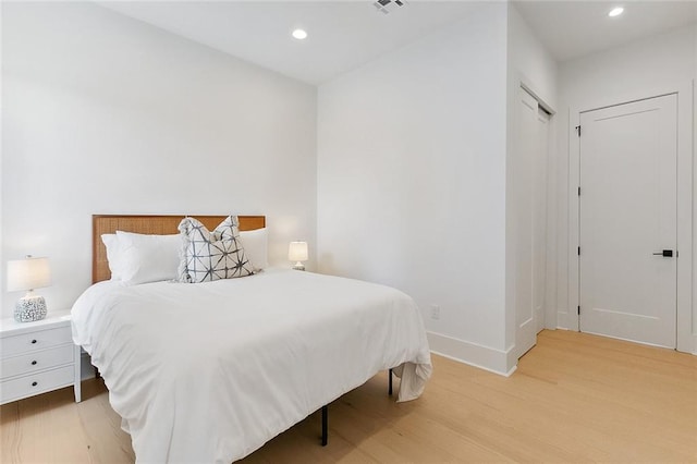 bedroom featuring a closet and light wood-type flooring