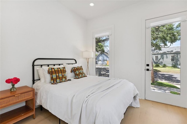 bedroom featuring access to exterior and light hardwood / wood-style floors