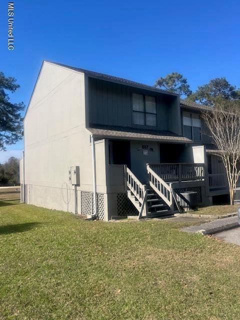 back of property featuring a lawn, covered porch, and central AC unit