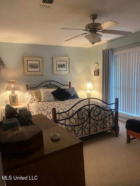 bedroom with ceiling fan and carpet