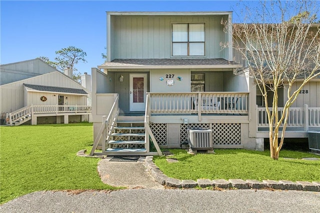 view of front of property featuring a porch, central AC unit, and a front lawn