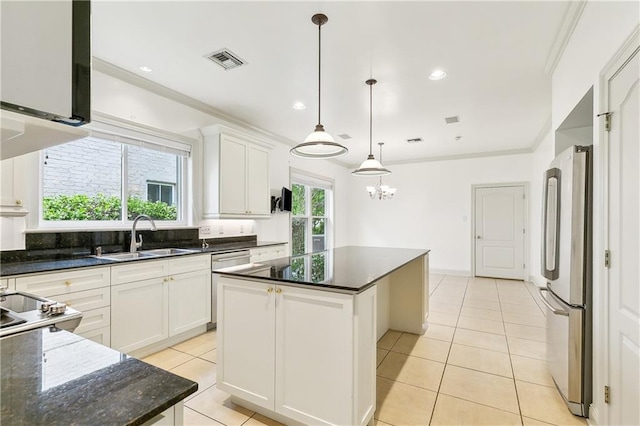 kitchen featuring a center island, a sink, light tile patterned floors, appliances with stainless steel finishes, and visible vents