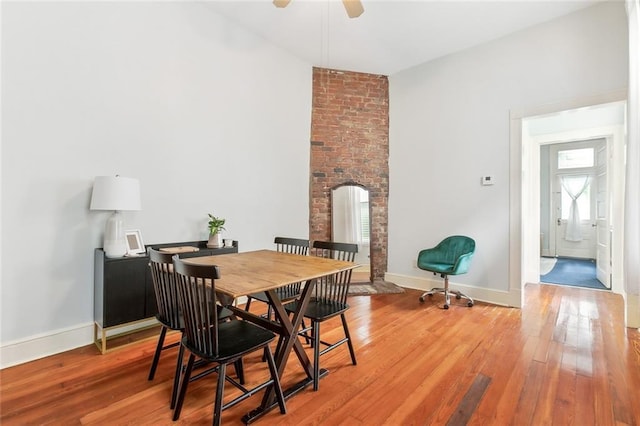 dining area with ceiling fan and hardwood / wood-style flooring