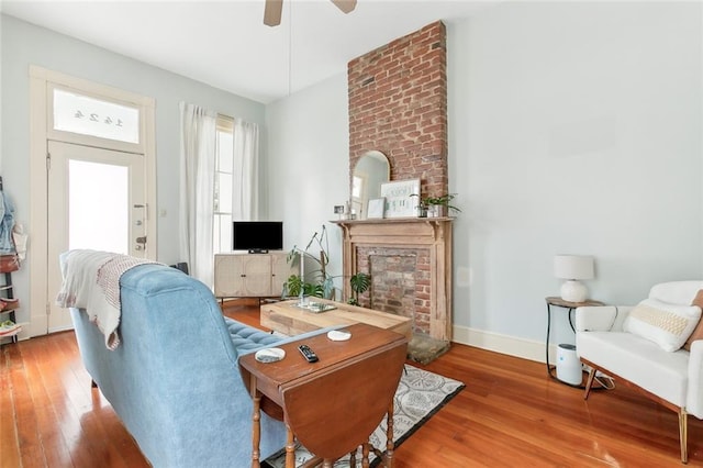 living room with ceiling fan and wood-type flooring