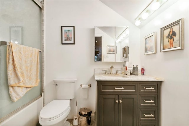 full bathroom featuring vanity, toilet, vaulted ceiling, and enclosed tub / shower combo