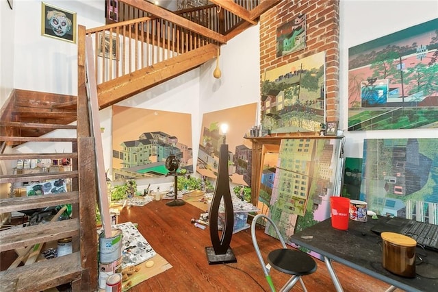 interior space featuring hardwood / wood-style floors and a towering ceiling