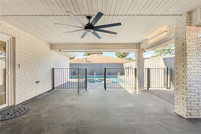 view of patio featuring a fenced in pool and ceiling fan