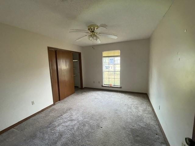 unfurnished bedroom with ceiling fan, carpet floors, and a closet