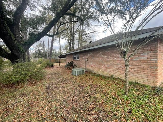 view of side of property with central AC