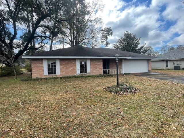 single story home featuring central AC, a garage, and a front lawn