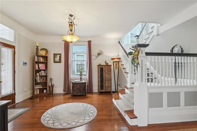 foyer entrance with dark hardwood / wood-style floors