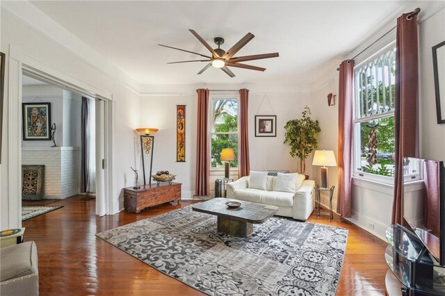 living room with hardwood / wood-style flooring, plenty of natural light, ceiling fan, and a fireplace