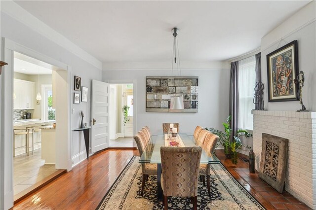 dining area with crown molding, a healthy amount of sunlight, and hardwood / wood-style floors