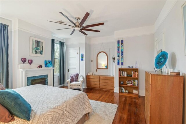 bedroom with ceiling fan and dark hardwood / wood-style floors