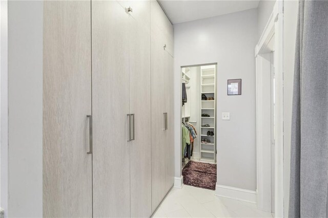 corridor featuring light tile patterned floors