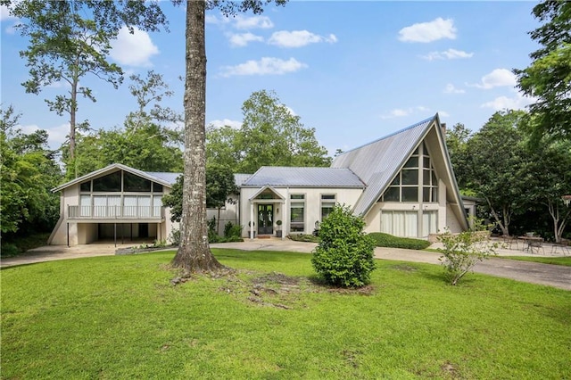 rear view of house featuring a lawn