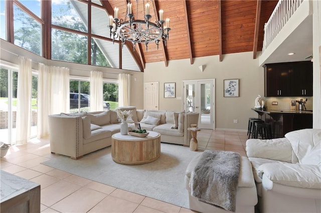 living room featuring high vaulted ceiling, wooden ceiling, light tile patterned floors, and an inviting chandelier